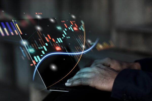 Forex chart and person's hands on laptop